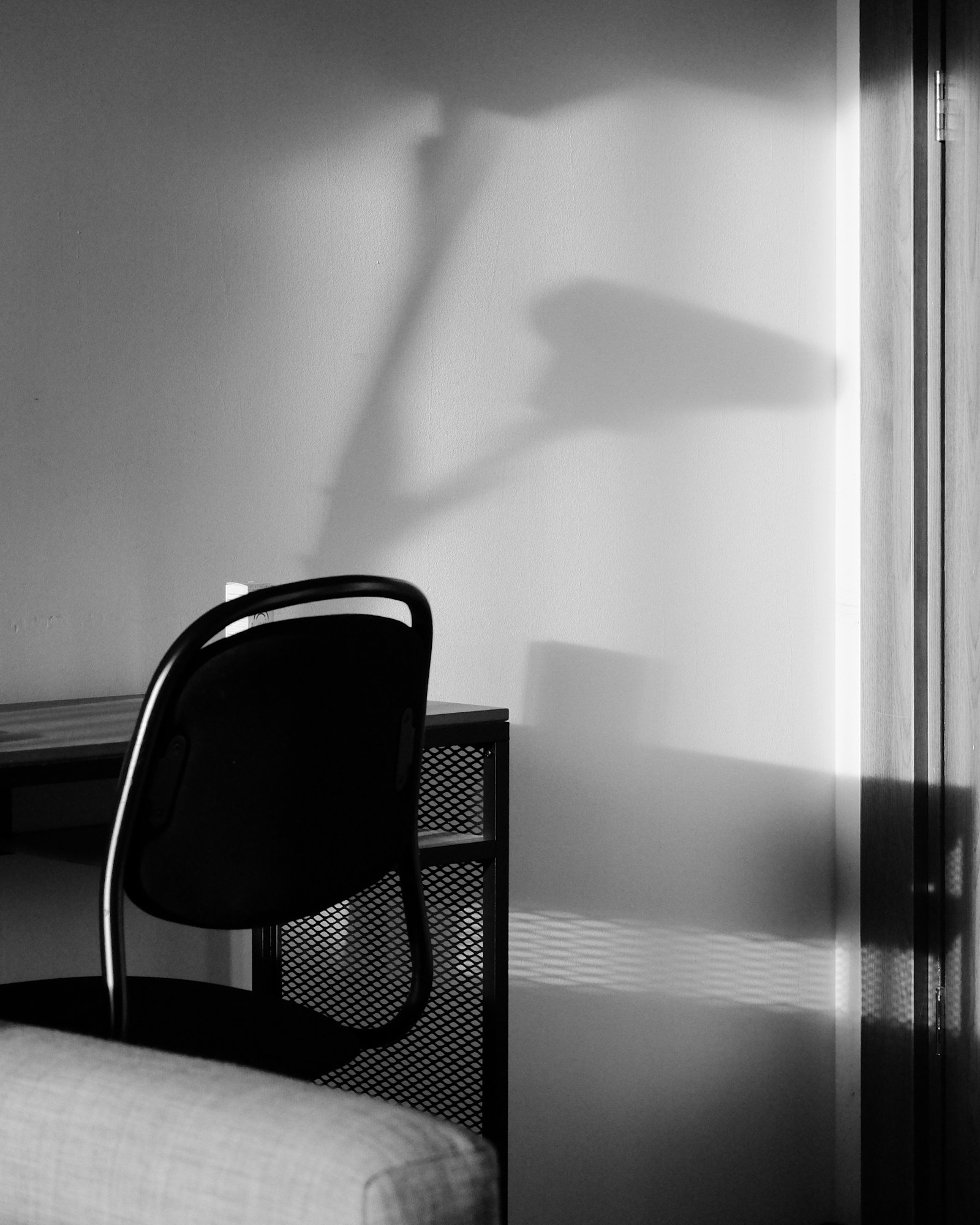 A chair and window shadow in a quiet room