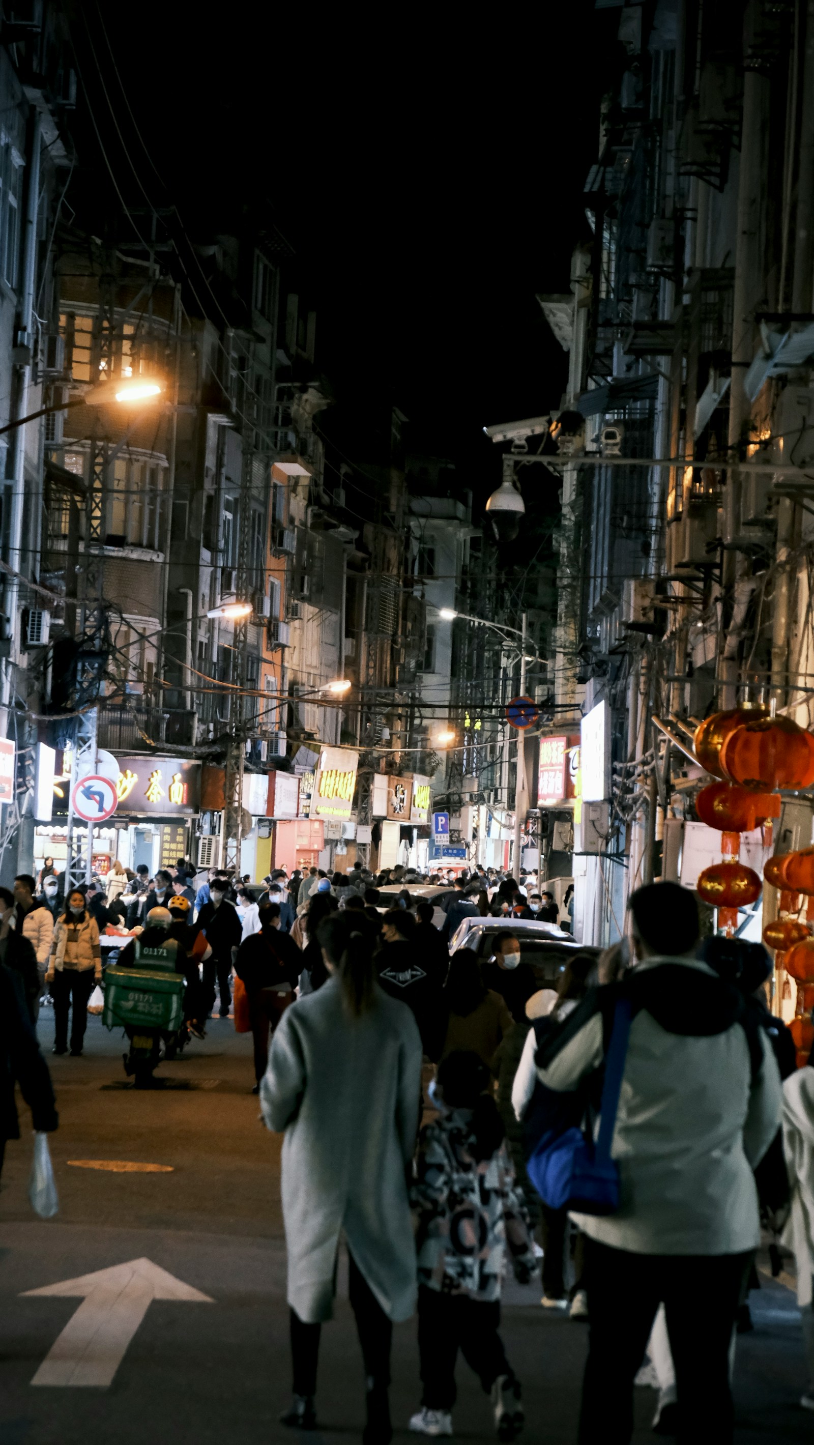 People walking along Zhongshan Street in Xiamen at night
